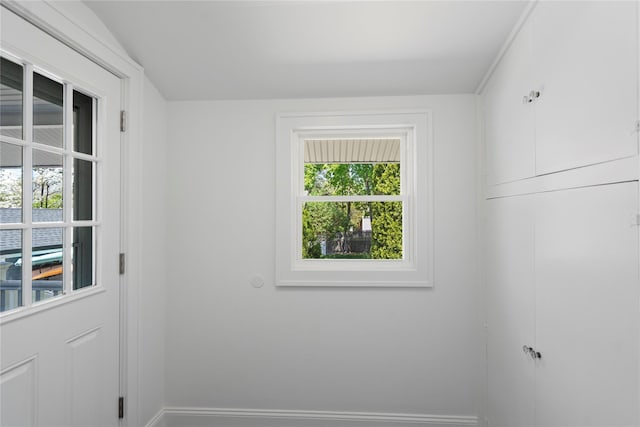 doorway to outside featuring baseboards