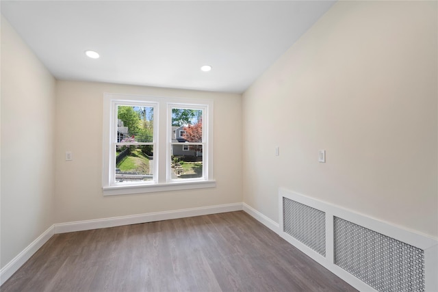 unfurnished room with baseboards, recessed lighting, and wood finished floors