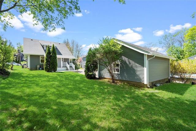 rear view of property with a yard