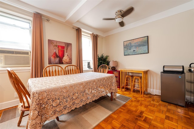 dining space featuring a ceiling fan, baseboards, cooling unit, and beam ceiling
