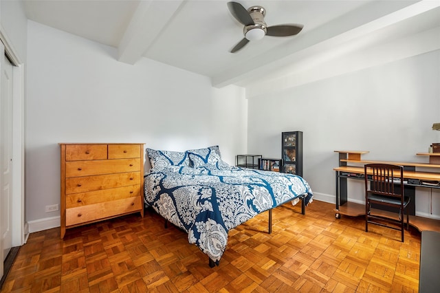 bedroom with beamed ceiling, a closet, and baseboards