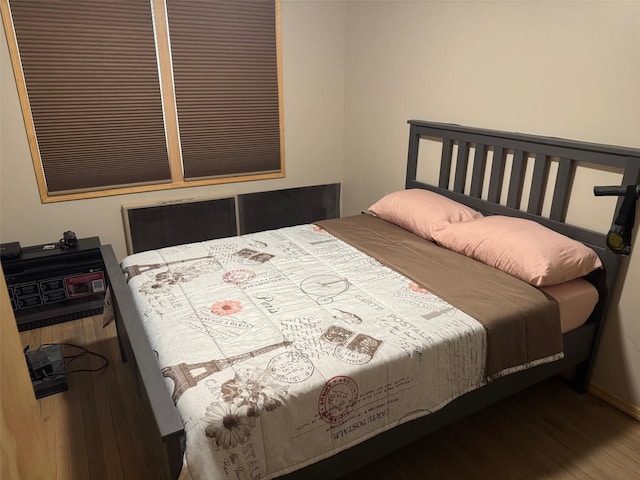 bedroom featuring wood finished floors