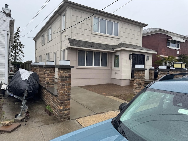 view of front of home with a shingled roof