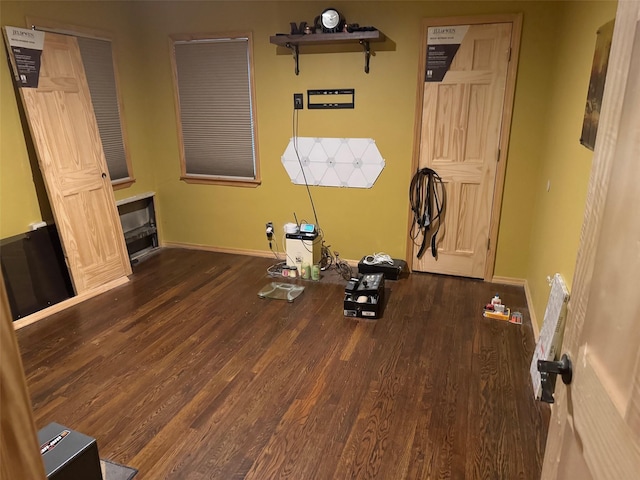 interior space featuring baseboards and wood finished floors