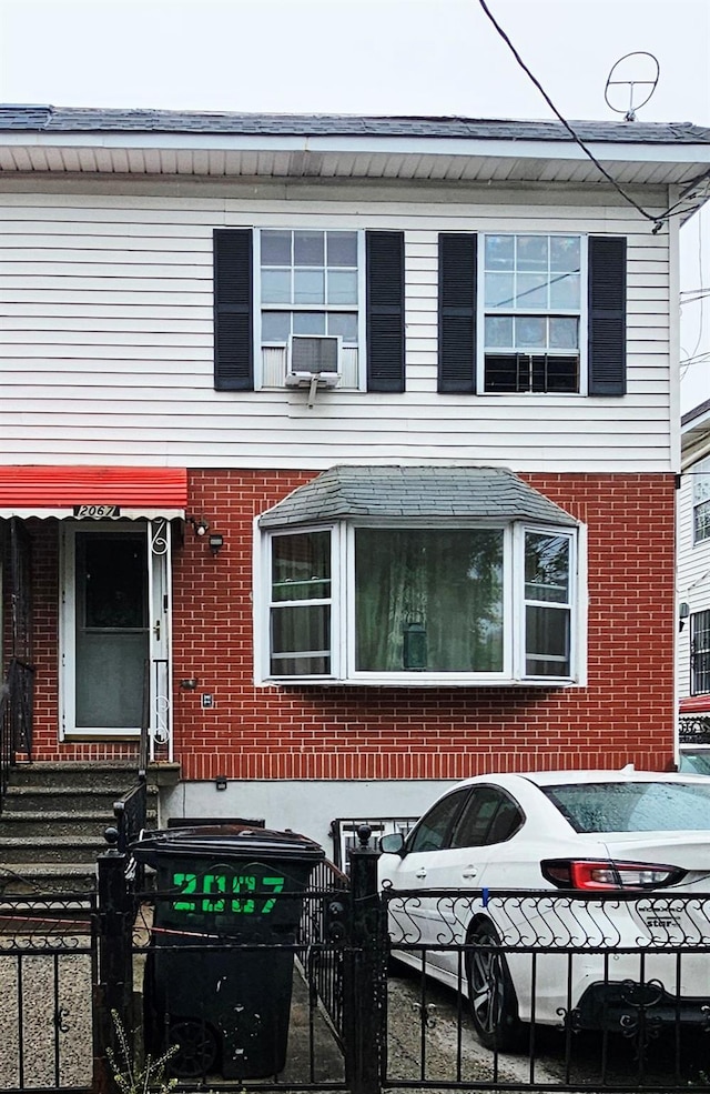 2067 Seward Ave, Bronx, NY 10473 - view of property featuring brick siding, a fenced front yard, and entry steps