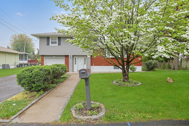 26 Hoke Dr, Stony Point, NY 10980 - view of front of house with a front yard, brick siding, a garage, and fence