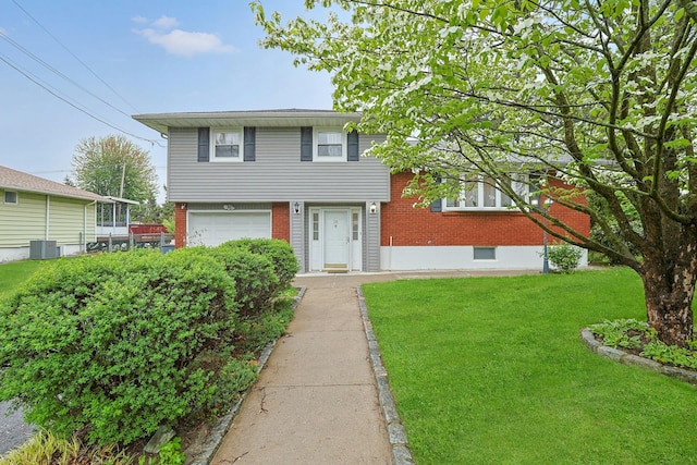 26 Hoke Dr, Stony Point, NY 10980 - tri-level home featuring brick siding, an attached garage, a front lawn, and central AC