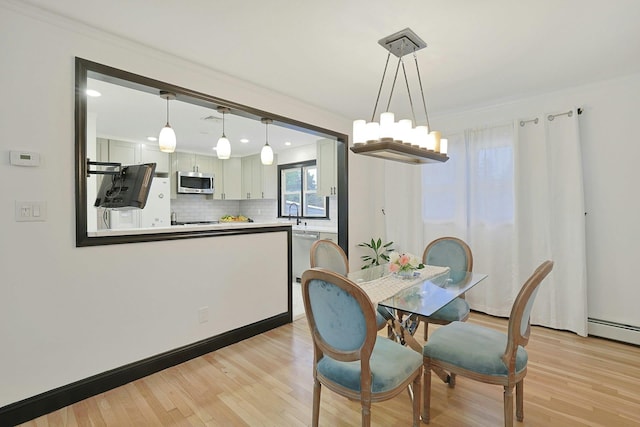 26 Hoke Dr, Stony Point, NY 10980 - dining area with a notable chandelier, light wood-style floors, a baseboard radiator, ornamental molding, and recessed lighting