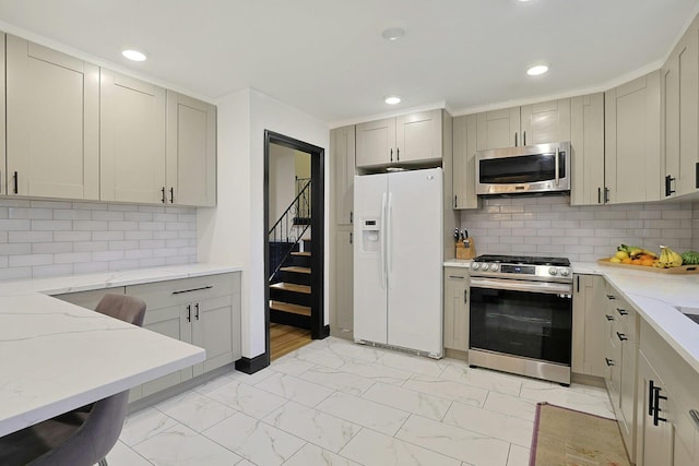 26 Hoke Dr, Stony Point, NY 10980 - kitchen featuring light stone countertops, recessed lighting, marble finish floor, decorative backsplash, and stainless steel appliances