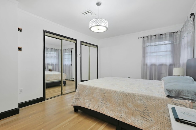 26 Hoke Dr, Stony Point, NY 10980 - bedroom featuring crown molding, two closets, visible vents, and wood finished floors
