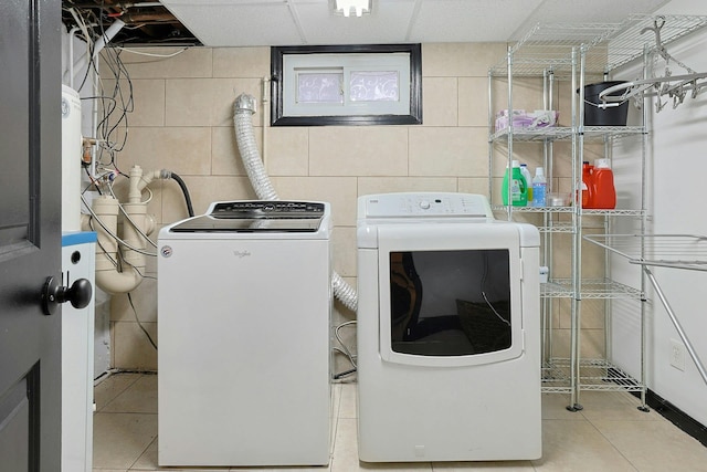 26 Hoke Dr, Stony Point, NY 10980 - clothes washing area with washing machine and clothes dryer, laundry area, concrete block wall, and tile patterned flooring