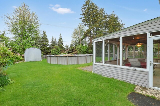 26 Hoke Dr, Stony Point, NY 10980 - view of yard featuring a sunroom, a storage shed, and an outdoor pool