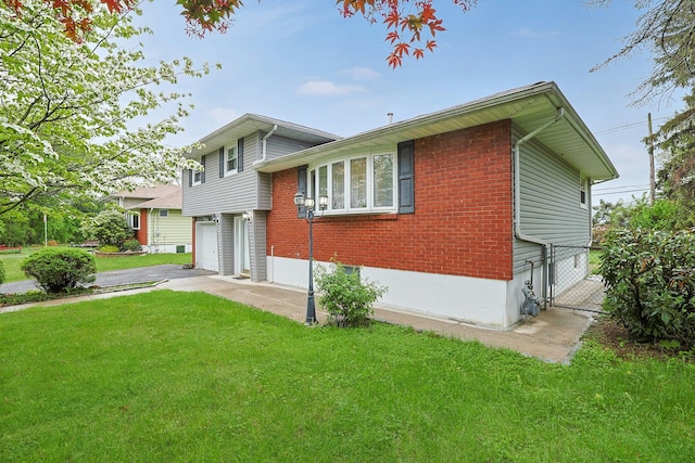 26 Hoke Dr, Stony Point, NY 10980 - exterior space featuring driveway, brick siding, fence, an attached garage, and a front yard