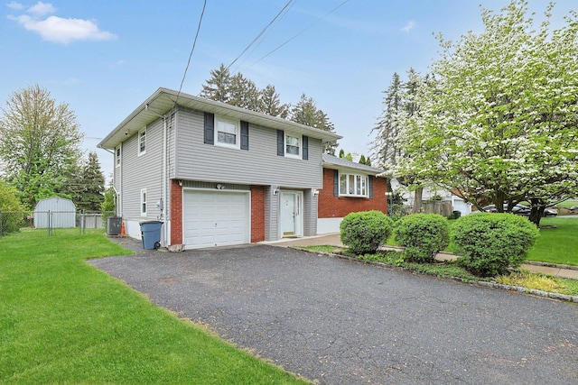 26 Hoke Dr, Stony Point, NY 10980 - tri-level home featuring brick siding, fence, a front yard, and aphalt driveway