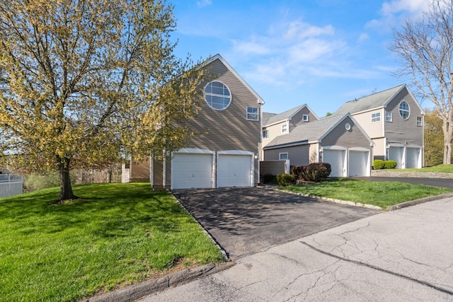 traditional home with a front lawn and aphalt driveway