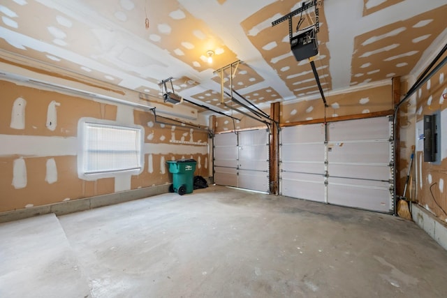 garage with a garage door opener and electric panel