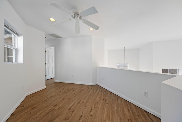 unfurnished room with visible vents, wood finished floors, baseboards, ceiling fan, and recessed lighting