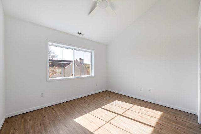 empty room featuring baseboards, a ceiling fan, wood finished floors, and visible vents