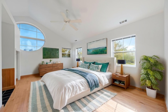 bedroom featuring ceiling fan, visible vents, multiple windows, and hardwood / wood-style flooring