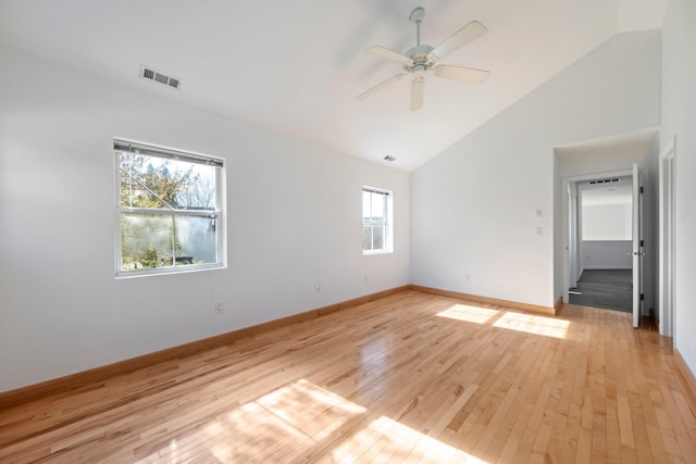 unfurnished bedroom with ceiling fan, light wood finished floors, high vaulted ceiling, baseboards, and visible vents
