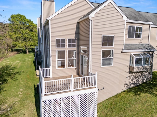 view of side of home with a yard and a chimney