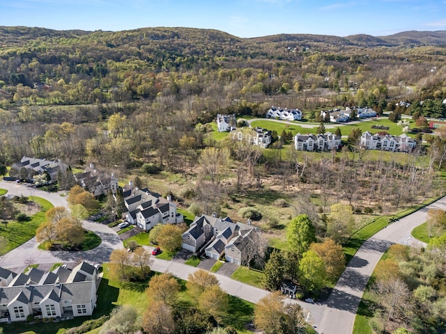 aerial view featuring a mountain view, a residential view, and a forest view