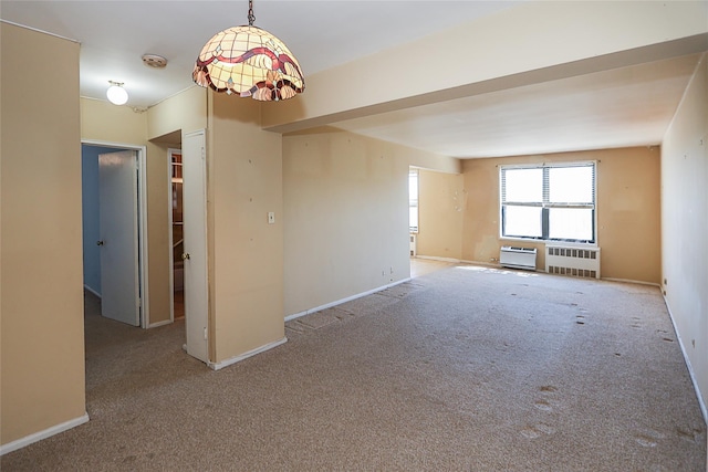 carpeted empty room with radiator heating unit and baseboards
