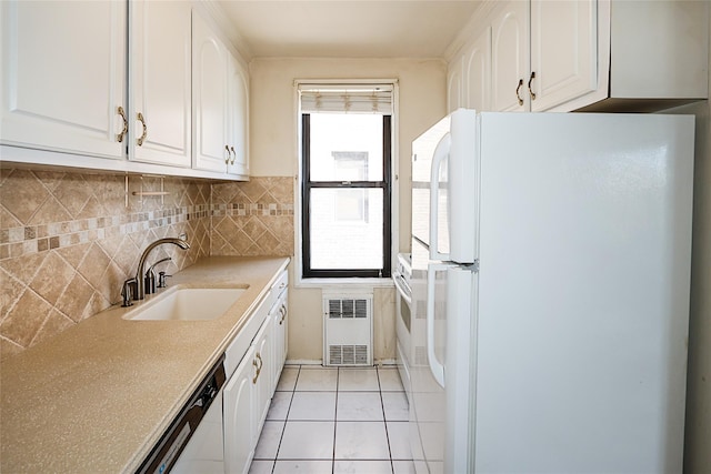 kitchen featuring a sink, light tile patterned floors, white cabinets, and white appliances