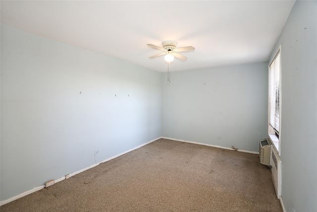 carpeted empty room with baseboards and a ceiling fan