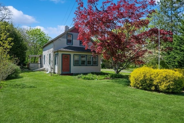 exterior space featuring a yard and a chimney