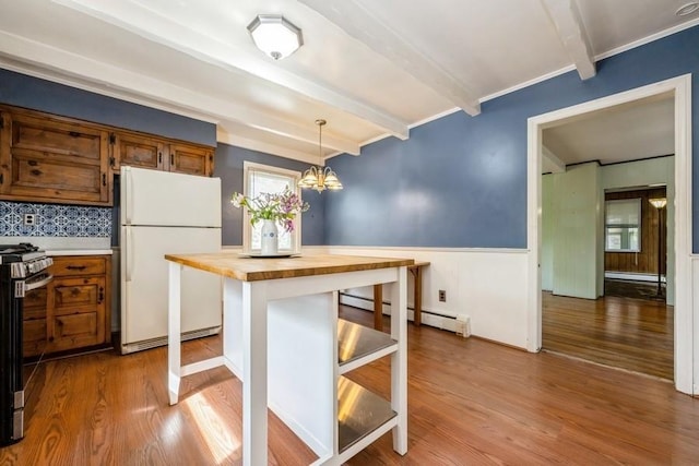 kitchen with beam ceiling, wooden counters, freestanding refrigerator, a baseboard radiator, and a baseboard heating unit