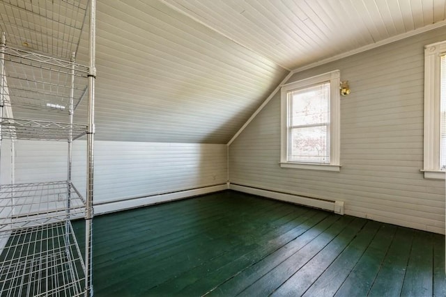 additional living space featuring dark wood finished floors and vaulted ceiling