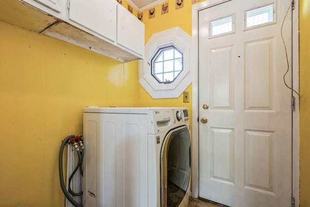 washroom with cabinet space and washer / clothes dryer
