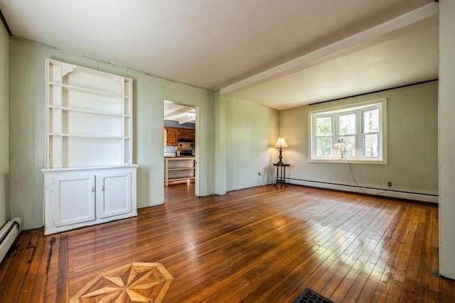 empty room featuring wood-type flooring and a baseboard radiator