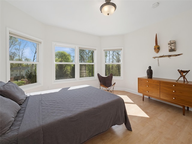 bedroom featuring baseboards and light wood-style flooring