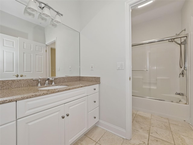 full bathroom featuring vanity, baseboards, and shower / bath combination