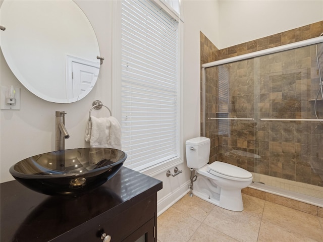 full bathroom featuring tile patterned flooring, vanity, toilet, baseboards, and tiled shower
