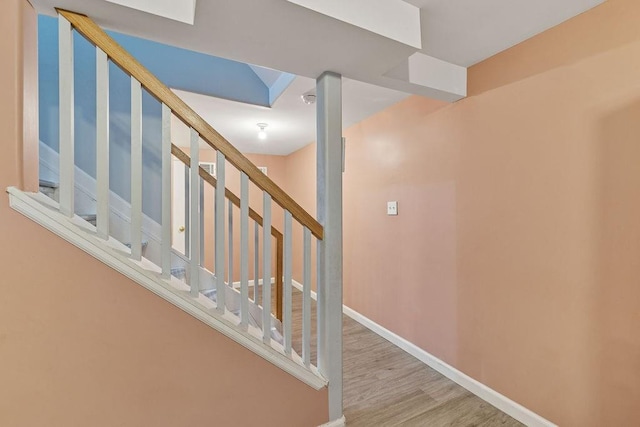 stairs with baseboards and wood finished floors
