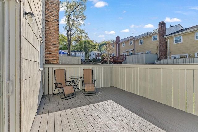 wooden terrace with a residential view