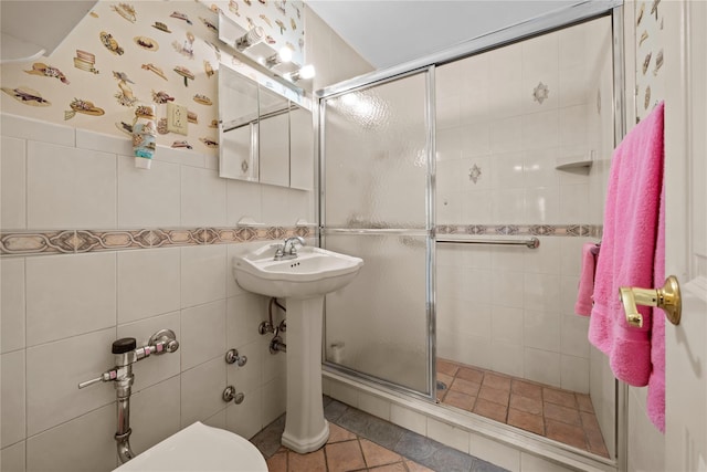 6300 Riverdale Ave Unit 5E, Bronx, NY 10471 - full bathroom featuring tile patterned flooring, a stall shower, toilet, and tile walls