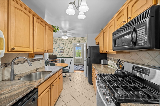 6300 Riverdale Ave Unit 5E, Bronx, NY 10471 - kitchen with light tile patterned flooring, a sink, ceiling fan with notable chandelier, wallpapered walls, and black appliances
