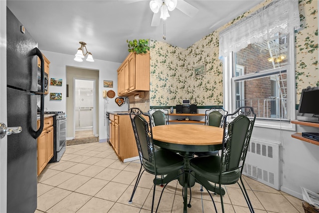 6300 Riverdale Ave Unit 5E, Bronx, NY 10471 - dining room with ceiling fan, radiator heating unit, light tile patterned flooring, and wallpapered walls