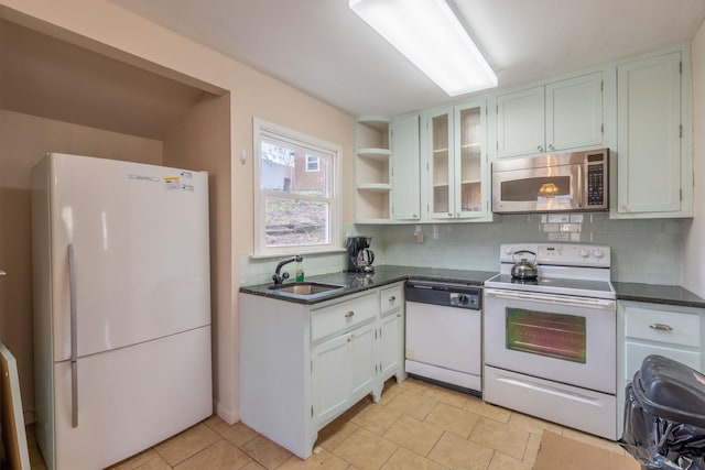 kitchen featuring open shelves, a sink, white appliances, light tile patterned floors, and backsplash