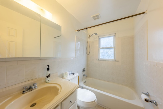 bathroom with shower / tub combination, vanity, toilet, tile walls, and visible vents