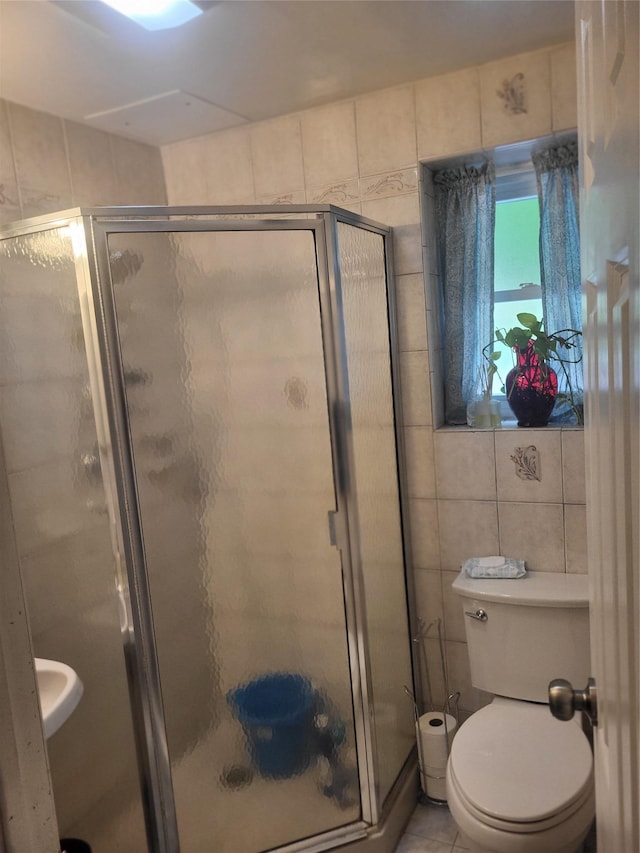 142 Pembrook Dr, Yonkers, NY 10710 - full bathroom with a shower stall, tile walls, tile patterned flooring, and toilet