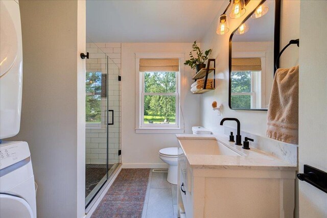 full bathroom with vanity, plenty of natural light, a shower stall, and toilet