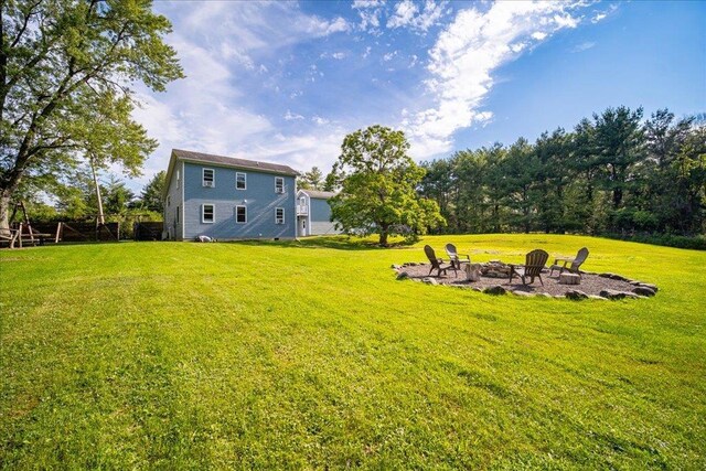 view of yard with a fire pit