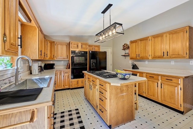 kitchen with a sink, light floors, black appliances, and light countertops