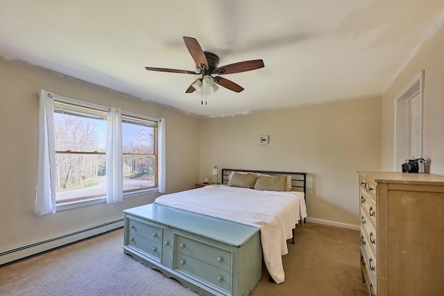 bedroom featuring baseboards, baseboard heating, a ceiling fan, and light colored carpet