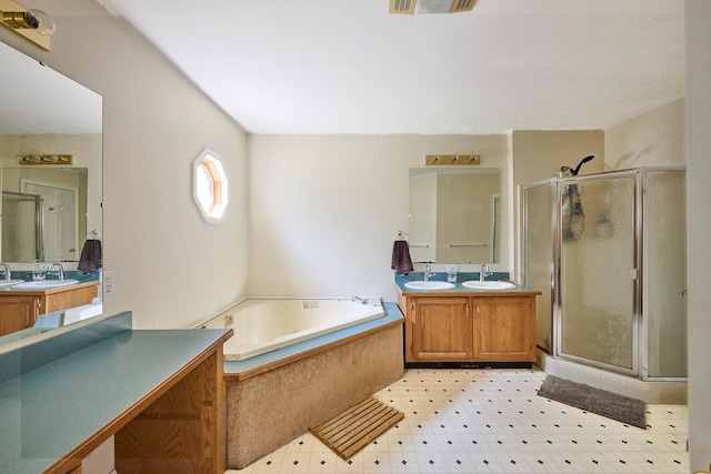 bathroom featuring a sink, a bath, tile patterned floors, and a shower stall